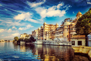 Romantic India luxury tourism wallpaper  - Vintage retro effect filtered hipster style image of Udaipur City Palace and Lake Pichola. Udaipur, Rajasthan, India
