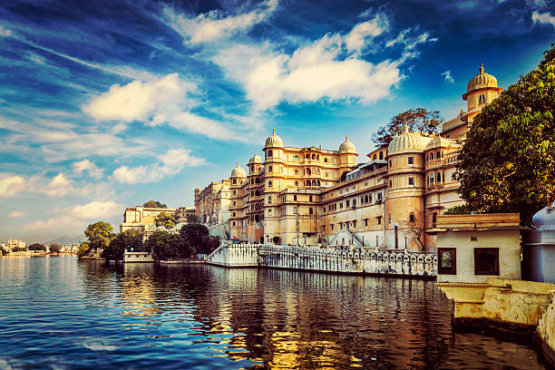 Romantic India luxury tourism wallpaper  - Vintage retro effect filtered hipster style image of Udaipur City Palace and Lake Pichola. Udaipur, Rajasthan, India