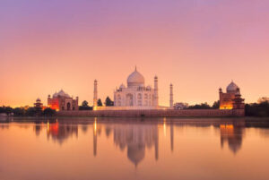 Taj Mahal reflecting in a river on sunset, Agra, India